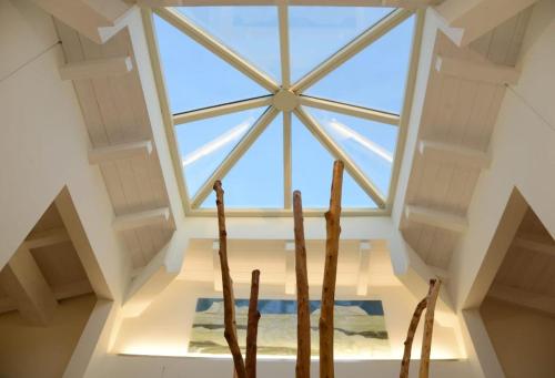 a skylight in a loft with two wooden chairs at ROOMS,REGGIO AFFITTACAMERE con Bagno Privato, TV, Clima , Wi-Fi in Reggio Emilia