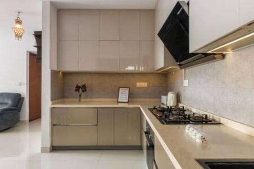 a kitchen with a stove and a counter top at Blue Pavilion by Red Olive Electronic city in Bengaluru