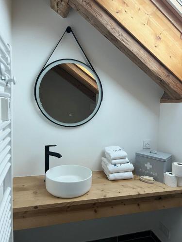 une salle de bain avec un lavabo et un miroir sur un comptoir dans l'établissement Chalet La Foge - Samoens x 14, skis aux pieds, à Morillon