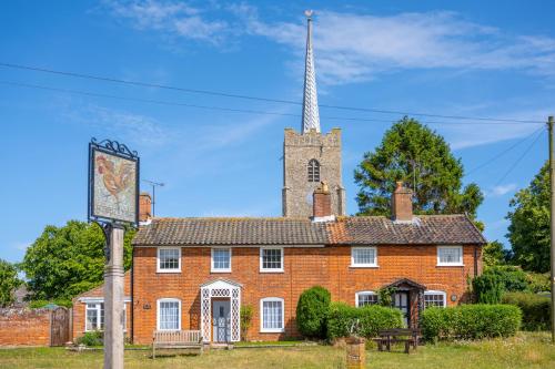 a large red brick building with a tower at Moles Meadow 4 in Middleton