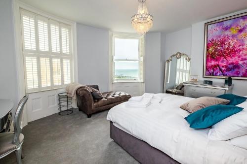 a bedroom with a large bed and a large painting on the wall at Beautiful Regency flat by Sea in Brighton & Hove