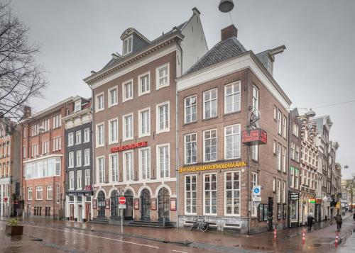 a large brick building on a city street at Hotel Oscar in Amsterdam