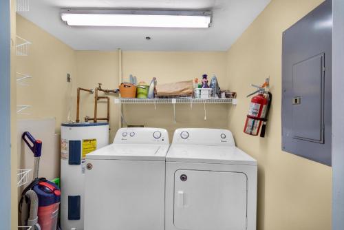 a laundry room with a white washer and dryer at Tristan Towers unit 14D in Pensacola Beach