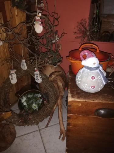 a dog standing next to a table with a christmas ornament at Lichtenhainer Hof in Lichtenhain