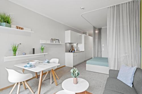 a living room with a couch and a table at HANS-Y Apartments inklusive Outdoorpool & Bar in Vienna