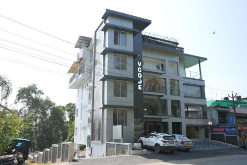 a building with a car parked in front of it at Vcode HillView in Thodupuzha
