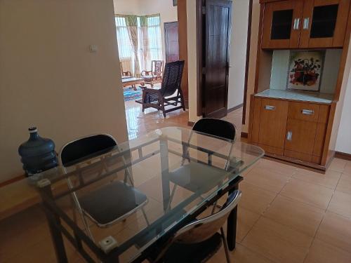 a glass table and chairs in a living room at Rumah Oma Lembang in Lembang