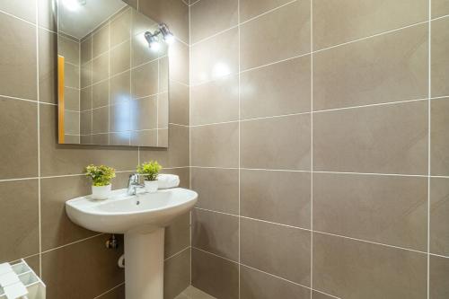 a bathroom with a sink and a mirror at Jouvacations Ripolles Figueres-Vilafant in Vilafant