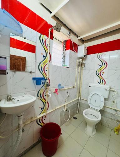 a bathroom with a toilet and a sink at RR Guest House in Kolkata