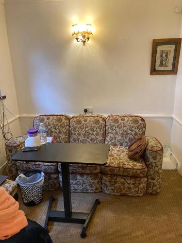 a living room with a couch and a table at Lurgan Road Luxury Retreat in Banbridge in Banbridge