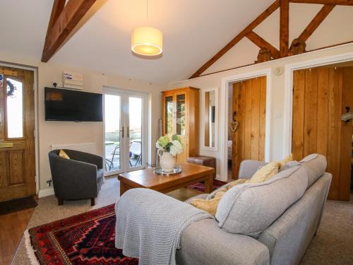 a living room with a couch and a table at Hillview in Kidderminster