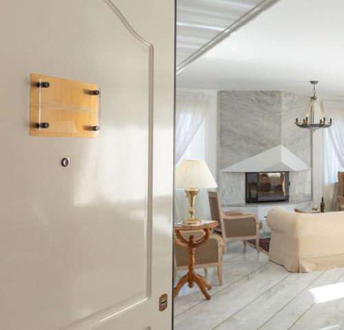a living room with a bed and a room with a fireplace at Nice Sea View Elegant Apartment in Athens