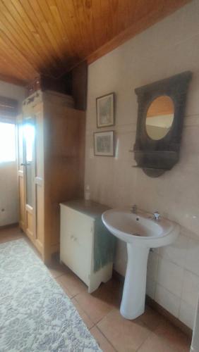 a bathroom with a sink and a mirror at Tranquility Guest House in Sabie