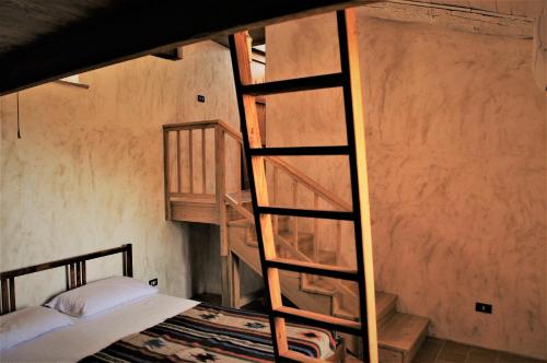 a room with two bunk beds and a ladder at A Curtigghiara Loft Savoca Central in Savoca 