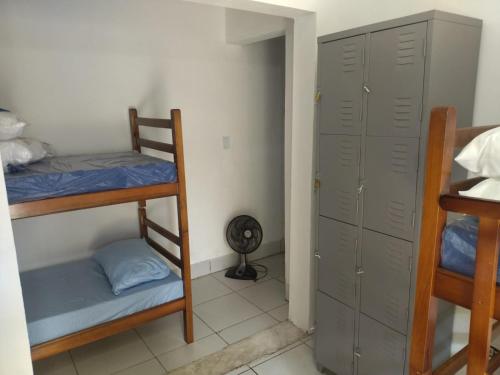 a room with two bunk beds and a closet at Quarto compartilhado in Bertioga