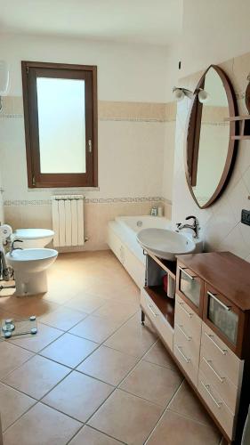 a bathroom with a tub and a toilet and a sink at Casa Daniela in Sarroch