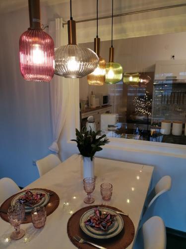 a dining table with two plates of food and lights at Alpenblumal in Bad Goisern