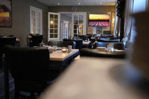 a restaurant with couches and tables and chairs at Prinsen Hotel in Aalborg