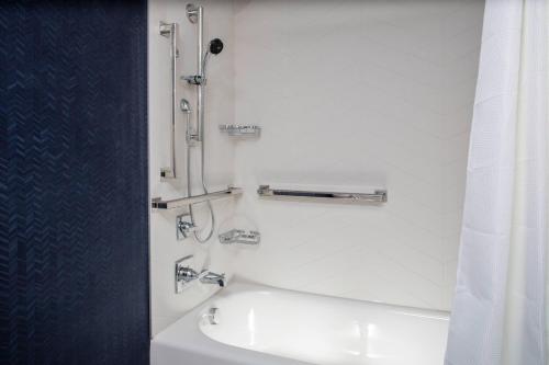 a white bathroom with a shower and a sink at Fairfield Inn & Suites Springfield Enfield in Springfield