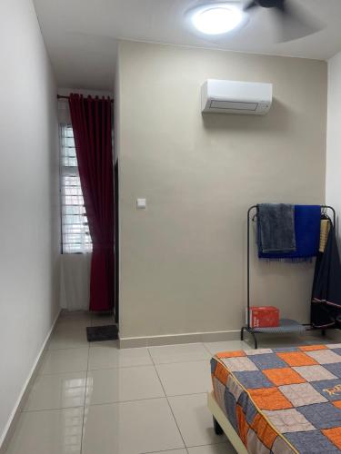 a bedroom with a bed and a air conditioner at Homestay Sakura in Padang Serai