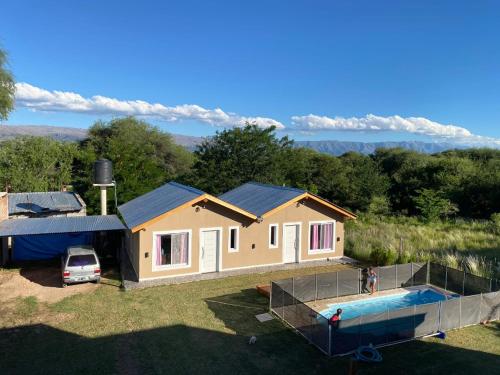 a house with a swimming pool in front of it at El Rincon de las Marias Casa en Planta Alta in San Lorenzo