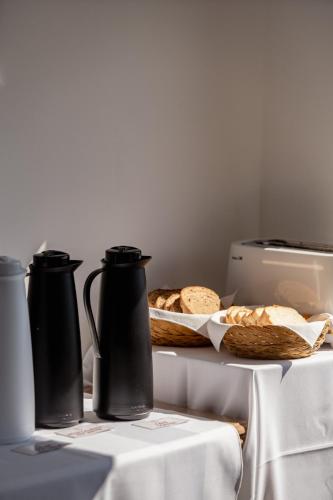 a table with two vases and a plate of bread at Los Fresnos in El Calafate