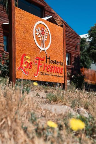 a sign for a hacienda fiesta sign in front of a building at Los Fresnos in El Calafate