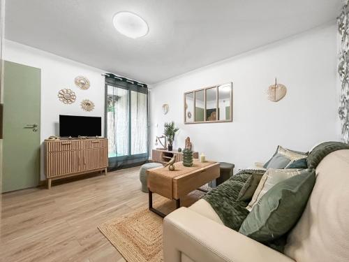 un salon avec un canapé et une télévision dans l'établissement Jardin privé, WiFi, proche de la mer, à Fréjus