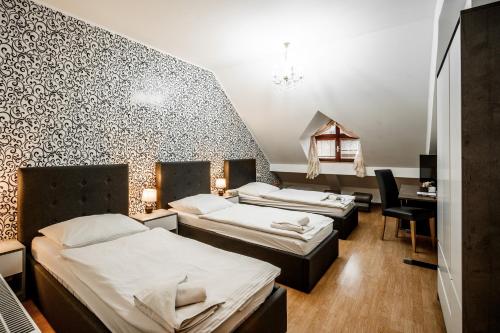 Postel nebo postele na pokoji v ubytování Hotel Panský dům