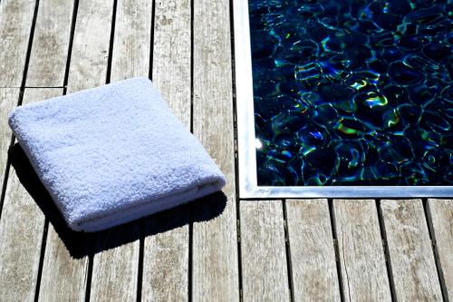 a towel sitting next to a pool of water at La Suite Gordes in Gordes