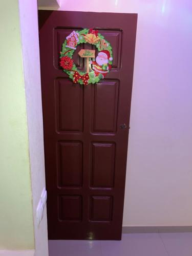a dark brown door with a wreath on it at Constança Retreat in Mindelo