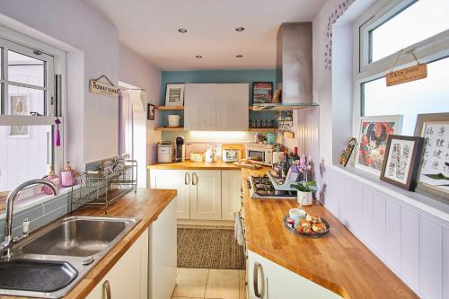 a kitchen with a sink and a counter top at Host & Stay - Lilac Cottage in Morpeth
