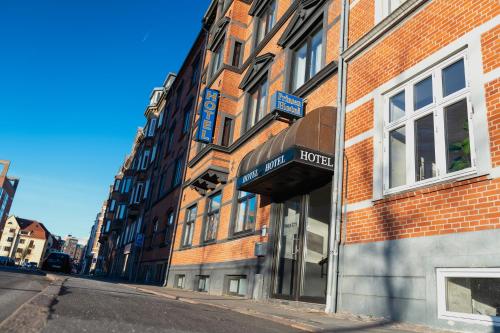 a facade of a brick building with a sign on it at Prinsen Hotel in Aalborg