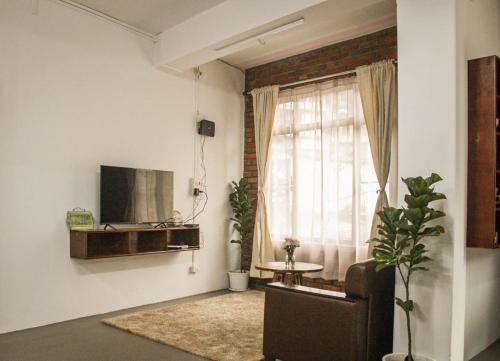 a living room with a couch and a window at R and H Stay in Kohīma