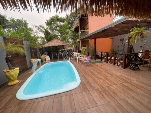 a swimming pool on the deck of a house at Casa de Praia, em Belterra - PA in Belterra