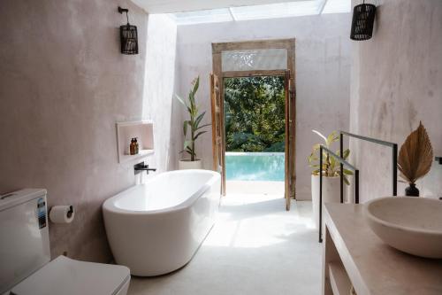 アハンガマにあるLuxury Jungle Villa with an Infinity Pool, Yoga Shala and Gymの大きな白い浴槽と洗面台のあるバスルーム
