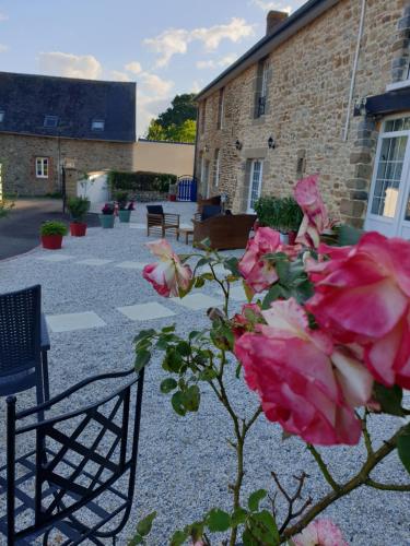 a bunch of pink roses in front of a building at Maison St. James in Saint-James