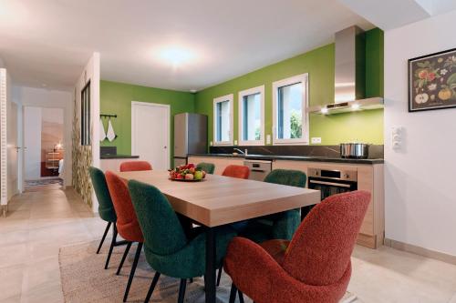 une cuisine et une salle à manger avec une table et des chaises dans l'établissement Le Logis de la Vicomté - Maison proche plage, à Dinard