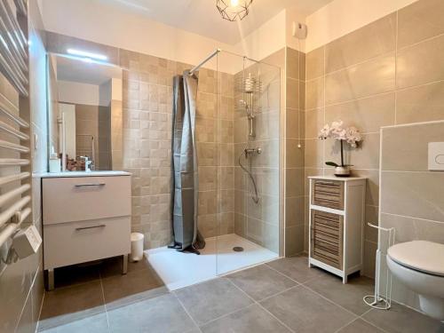 a bathroom with a shower and a toilet and a sink at Brand new flat with terrace and parc view in Nice