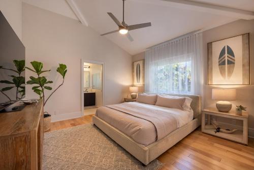 a bedroom with a large bed and a window at Hihimanu House in Princeville