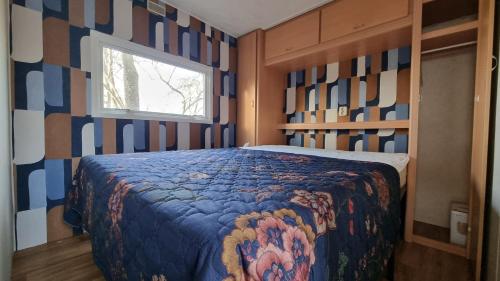 a bedroom with a bed with a colorful blanket at City Farmer Farmyard Stays, Sleep Easy, Stay Rural, Explore Amsterdam in Amsterdam