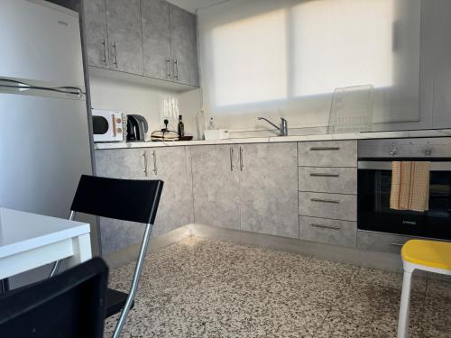 a kitchen with a sink and a stove top oven at Nikolas and Persefoni Flats in Yeroskipou