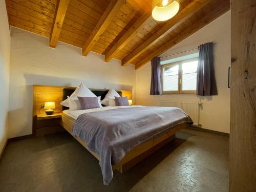 a bedroom with a large bed and a window at Ferienwohnungen Ellen Müller in Fischen