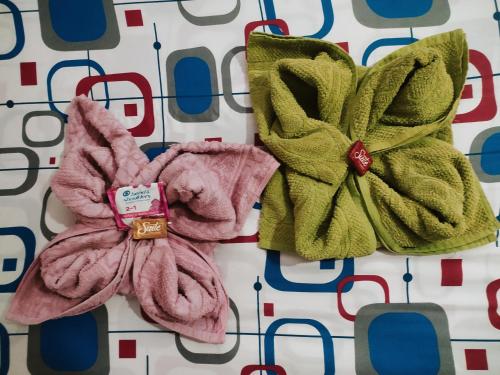 two towels sitting next to each other on a pattern at Kakuna Lodge in Minca