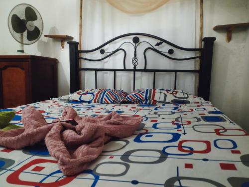 a bed with two stuffed animals laying on it at Kakuna Lodge in Minca