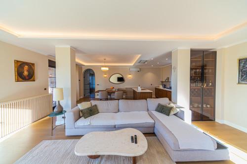 a living room with a white couch and a kitchen at Villa Seaside Shore in Budva
