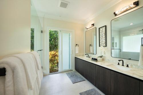 a bathroom with a sink and a large mirror at Hihimanu House in Princeville
