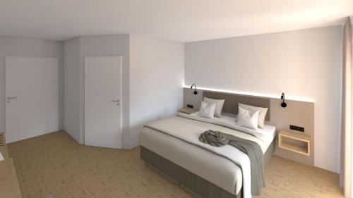 a bedroom with a large bed with white walls at Nest Hotel Nordhorn in Neuenhaus