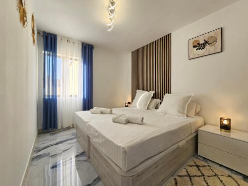 a bedroom with a large bed with white sheets at Mareverde Dream in Costa de Adeje