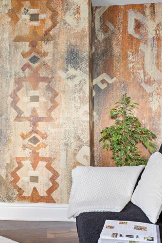 a room with a couch and a wall with a rug at Luxury Holiday Apartments in Torquay